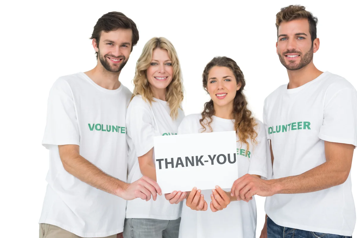 volunteers holding thank you board