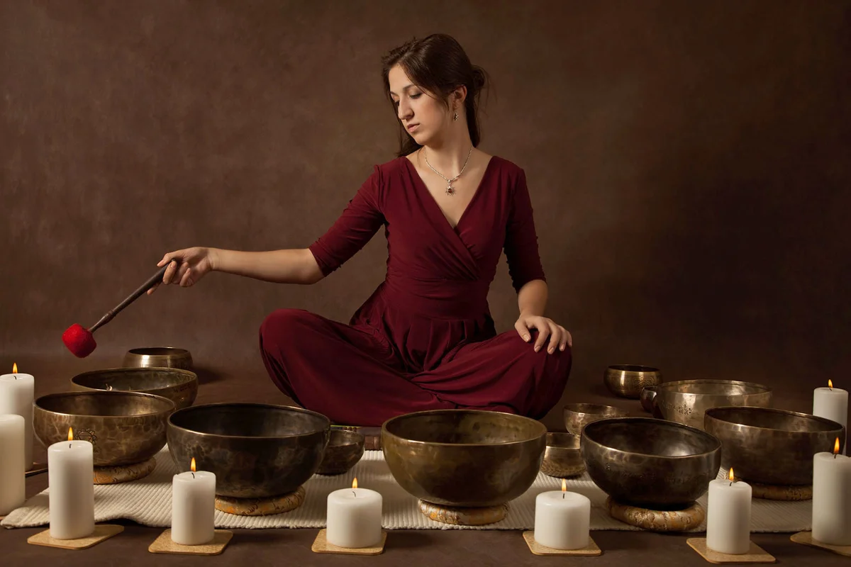 Woman playing Tibetan singing bowls