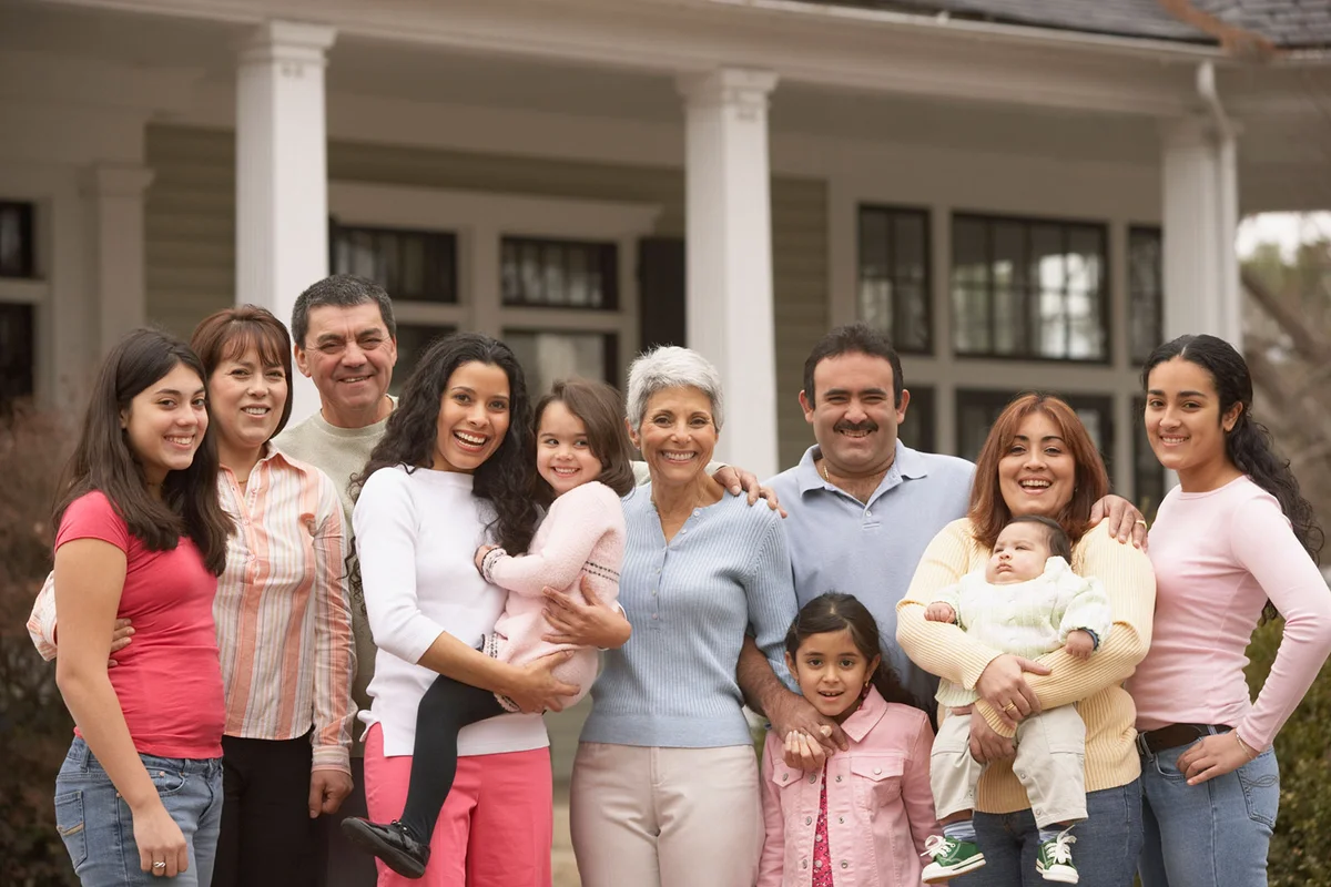 Big family in front of house