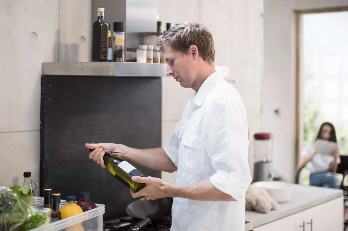 Man looking at wine bottle