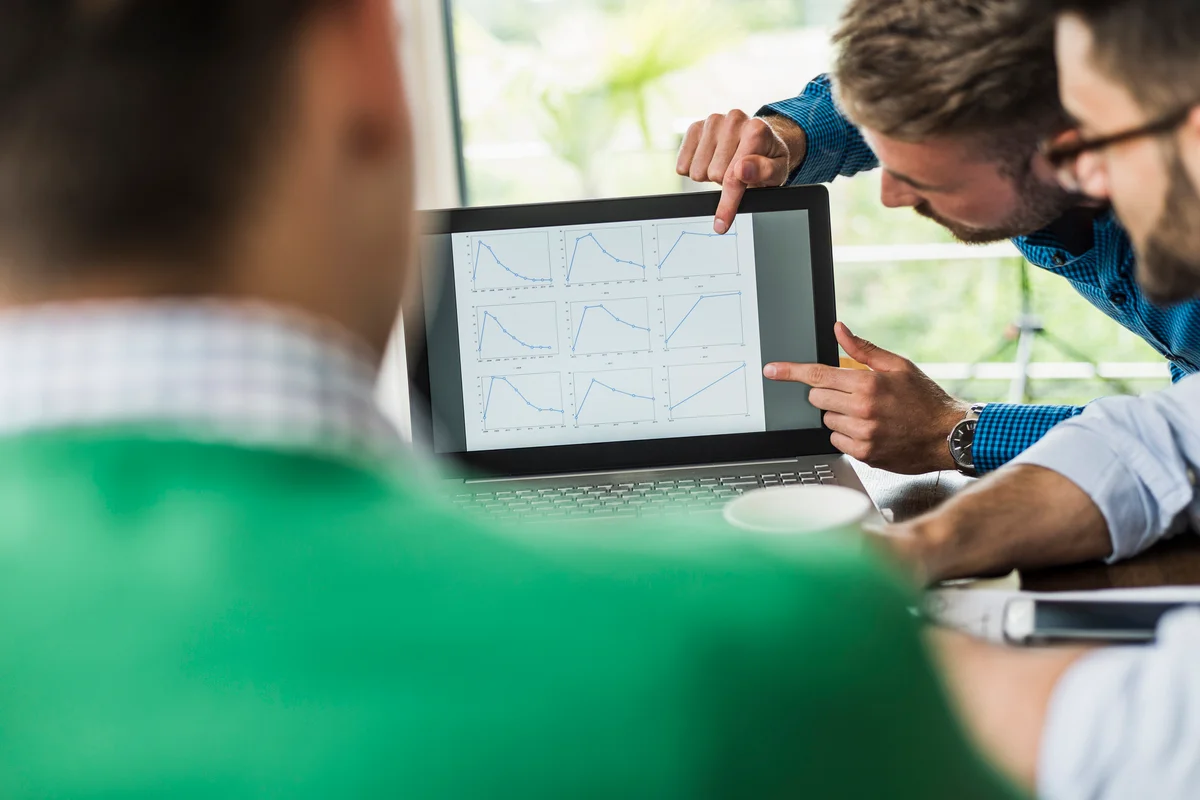 businessmen analyzing graphs