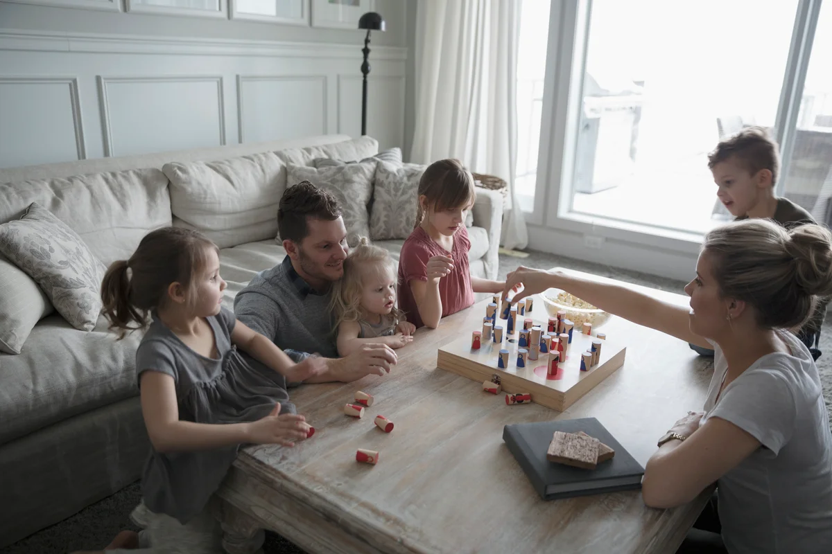 family playing game on coffee table