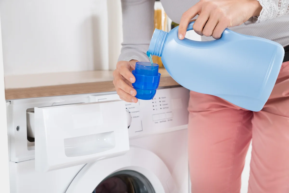 Pouring Detergent In Bottle Cap