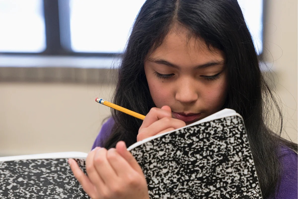girl writing in journal