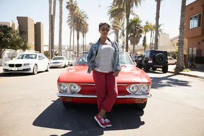 woman standing in front of car