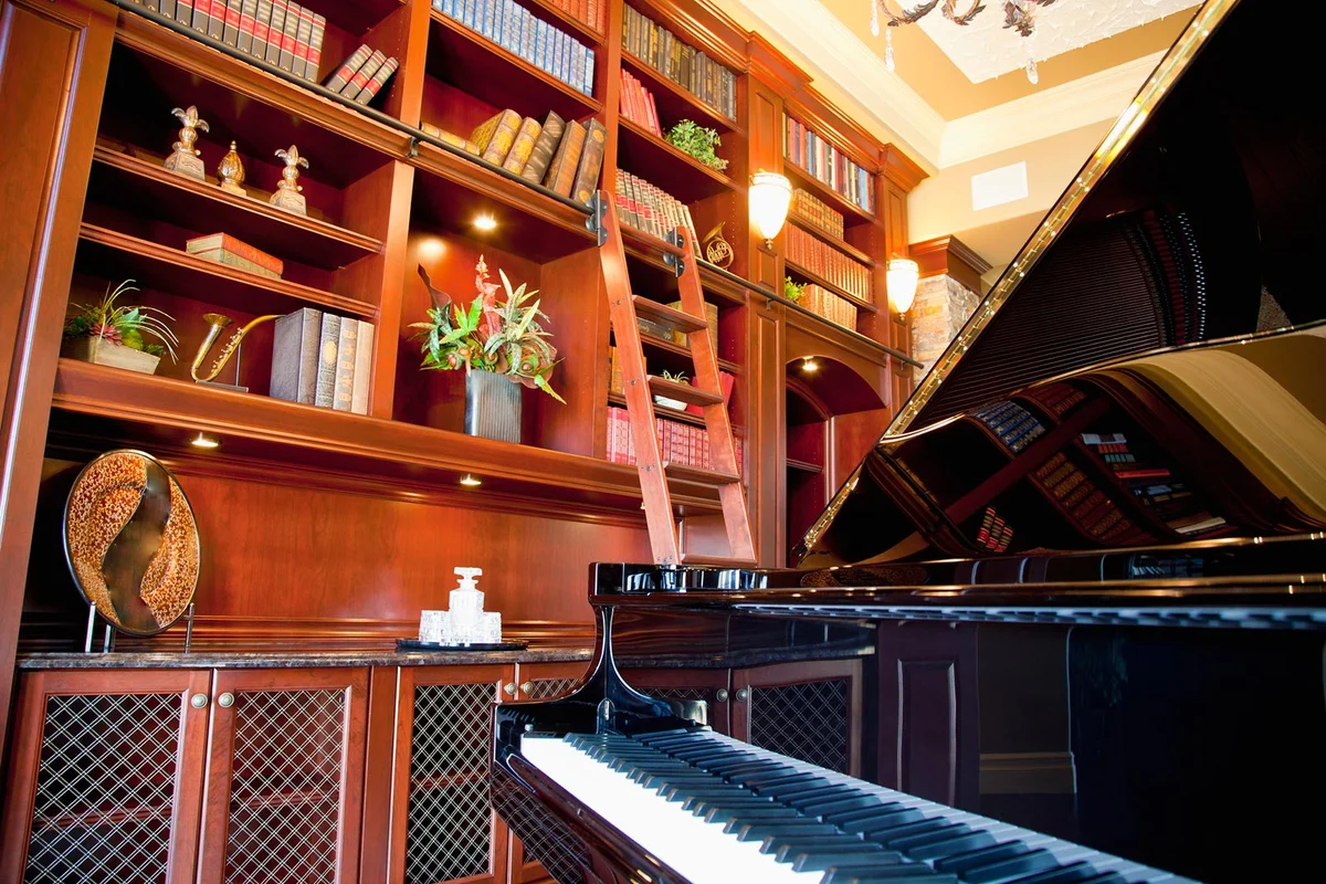 Room with books and piano