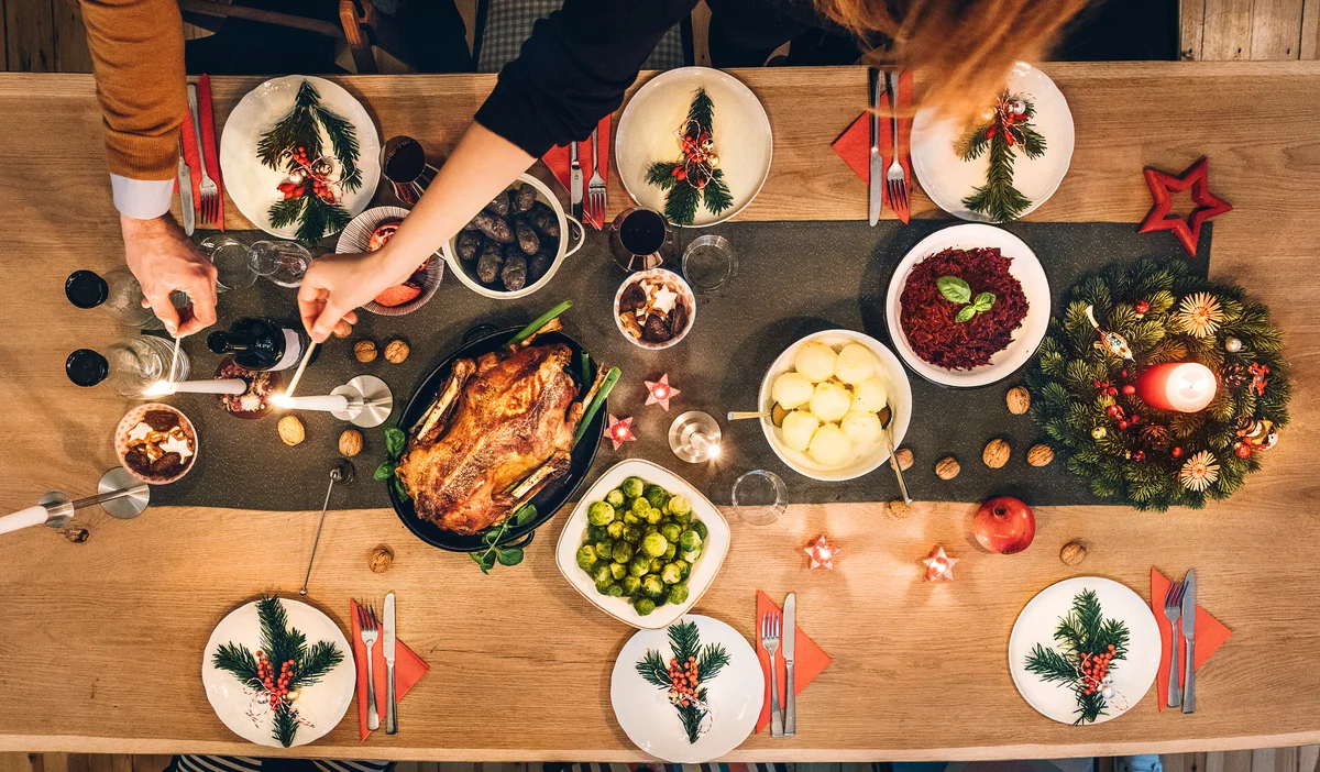 Overhead view of friends prepare table for christmas party