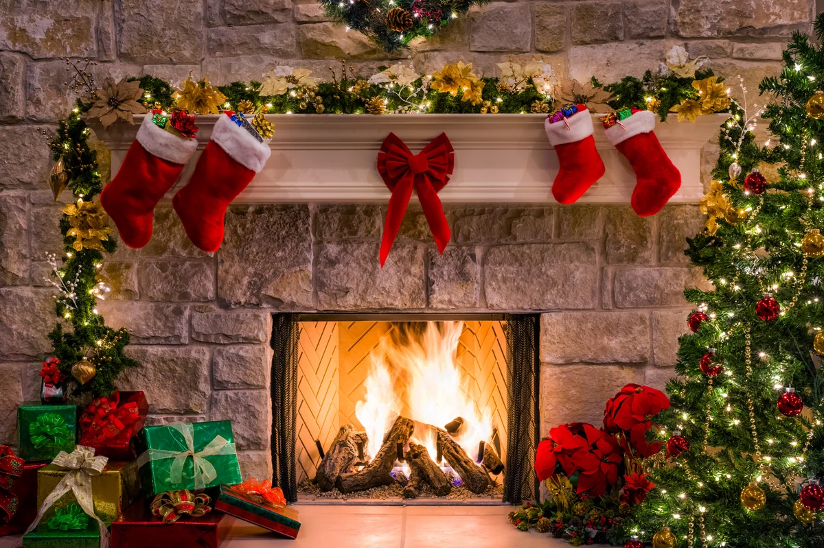 Christmas tree and stockings over fireplace