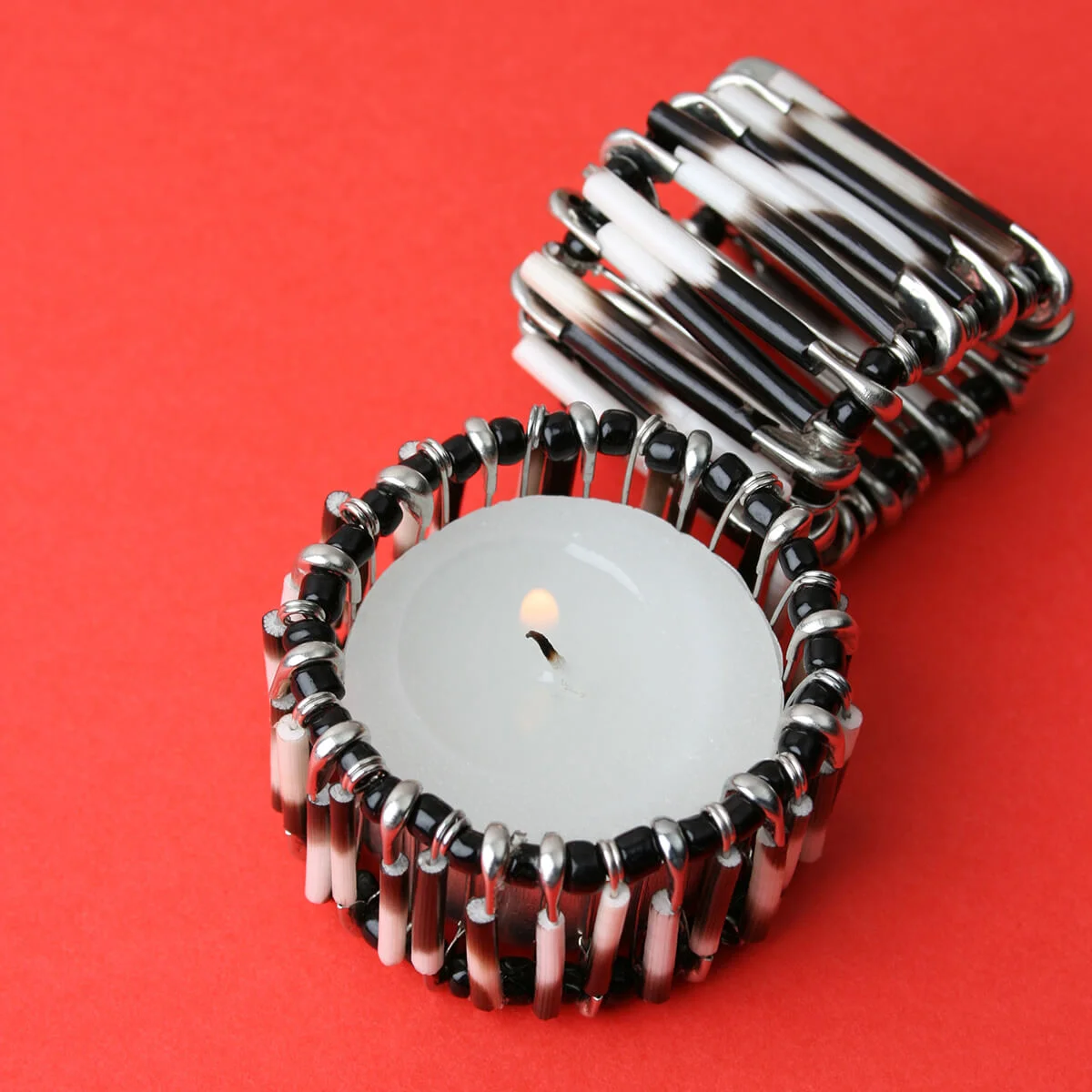 Safety pin candle holder