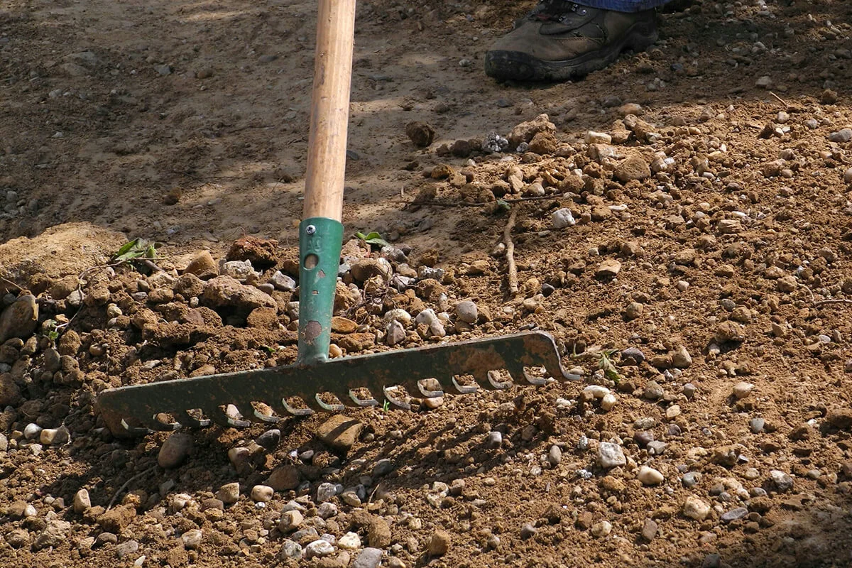 Man Working Field Through Rake