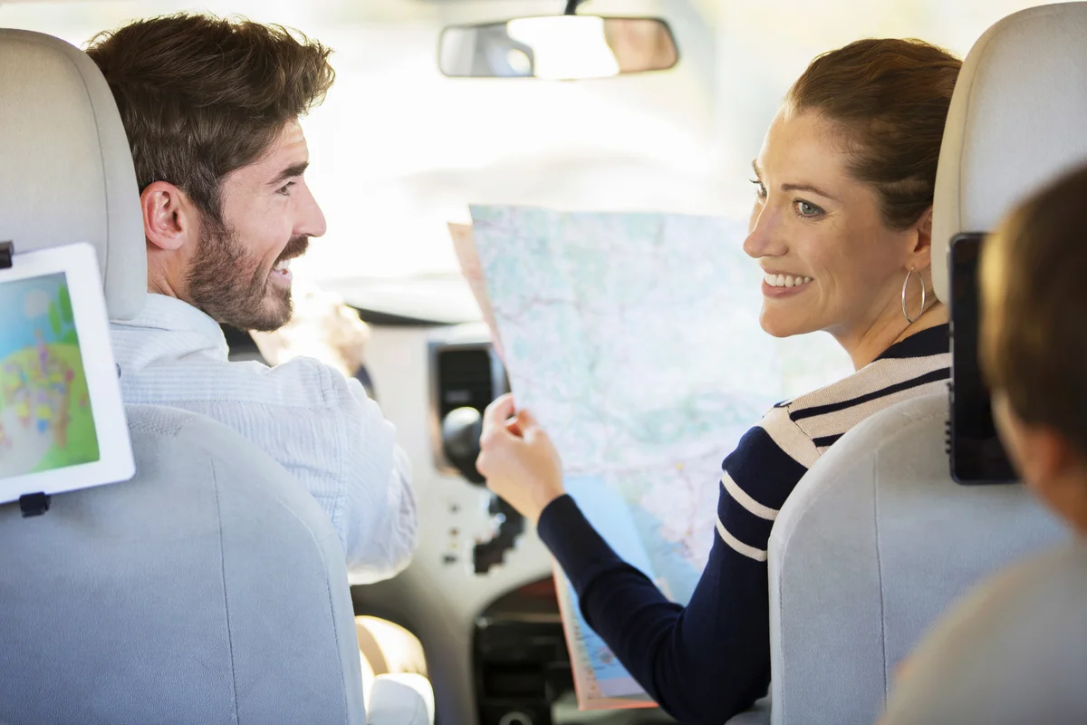 Family with map inside the car