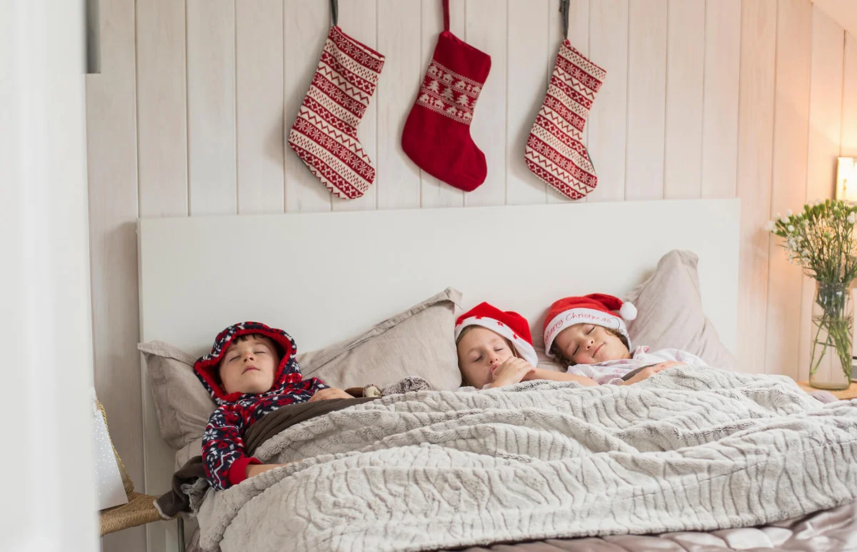 Three children in a double bed