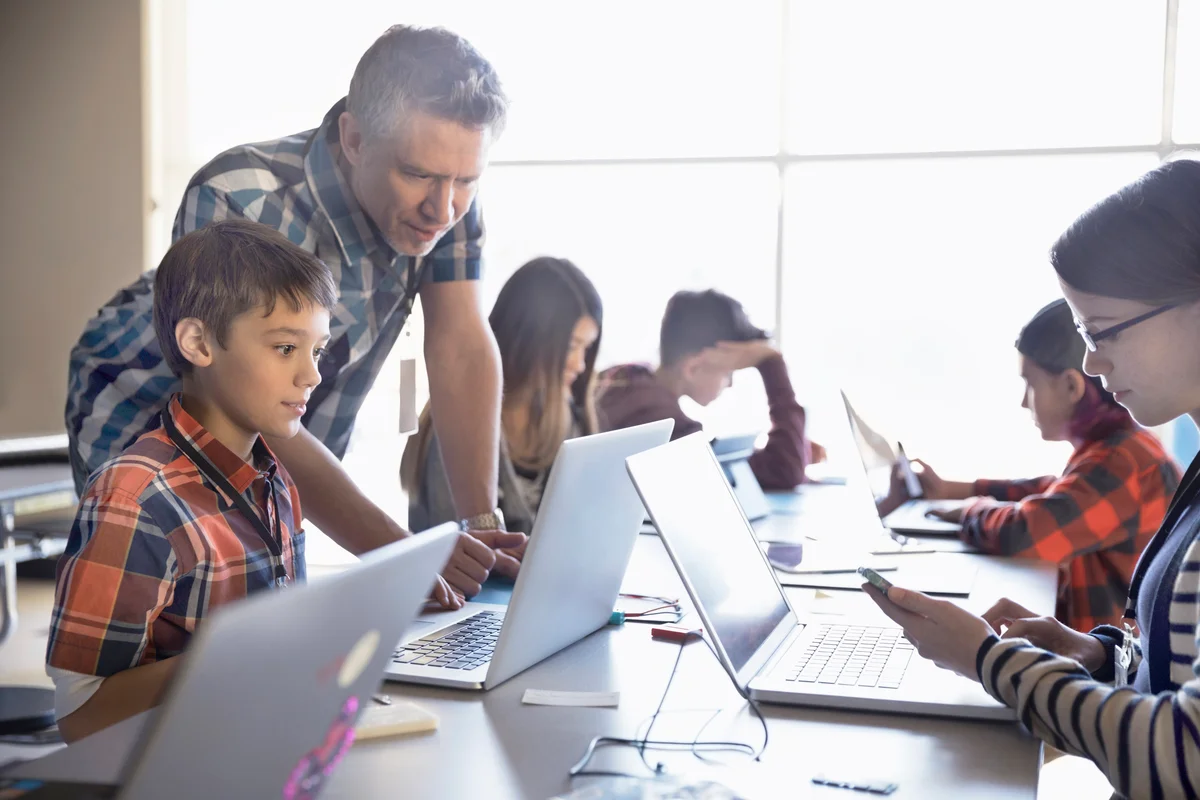 Teacher helping students