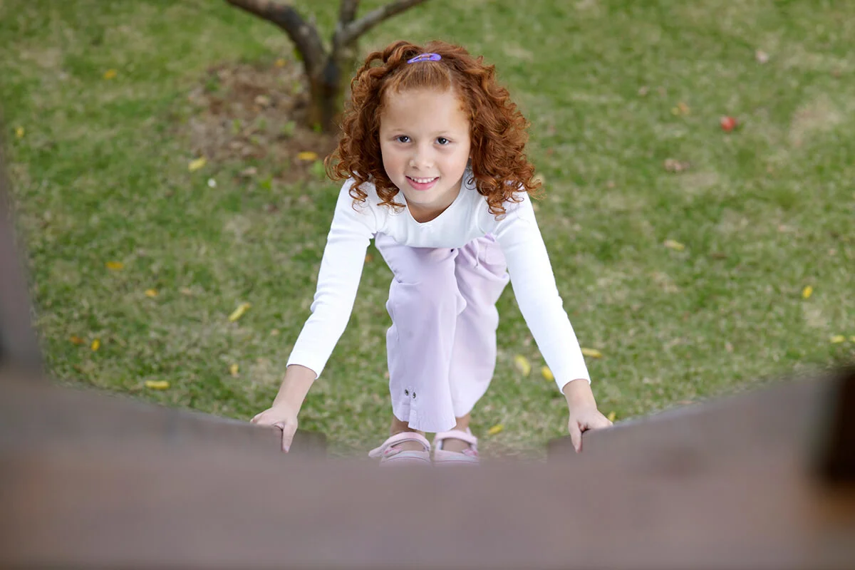 Girl climbing tree house ladder