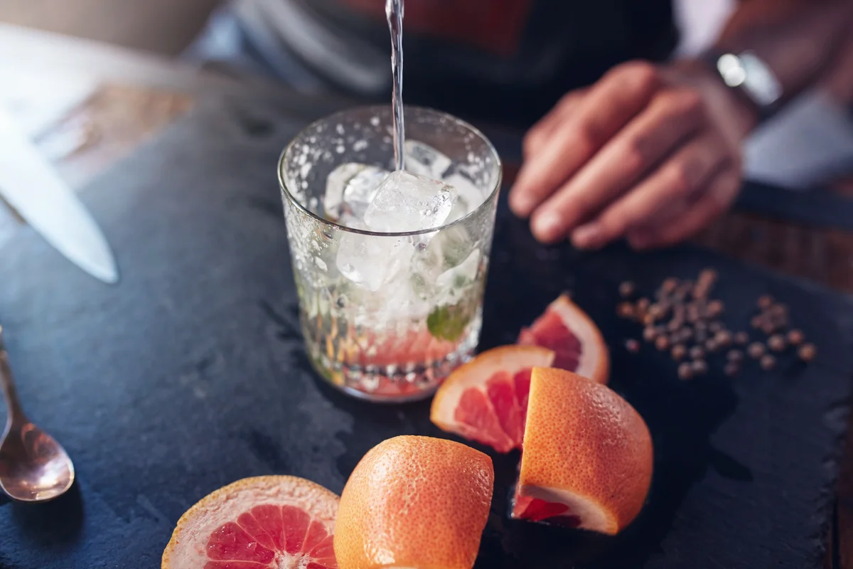 Bartender preparing grapefruit cocktail