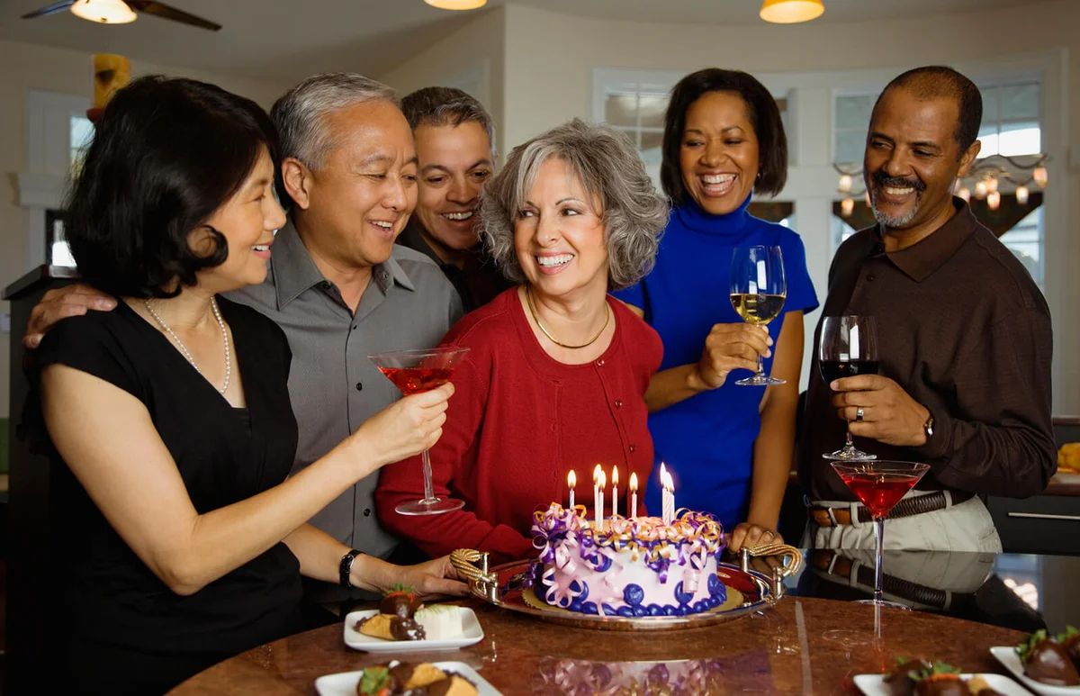 Woman celebrating birthday with multi-ethnic friends