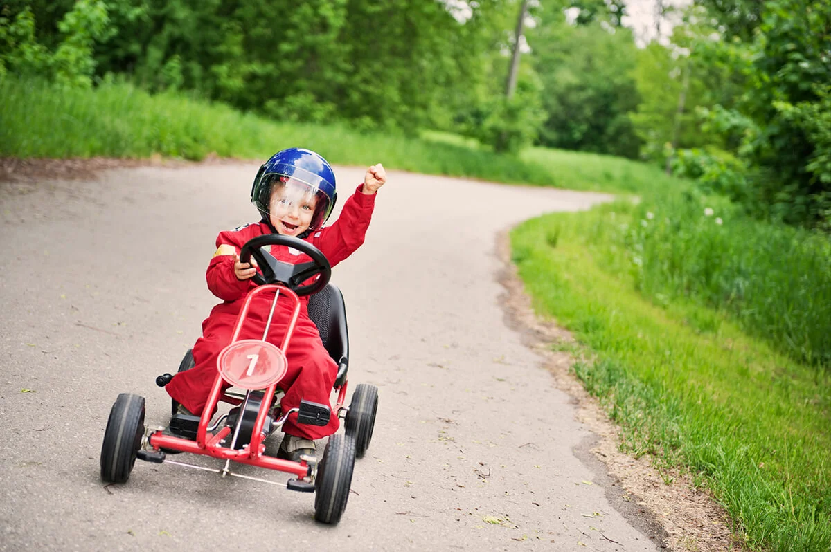 Little boy winning a go-kart race