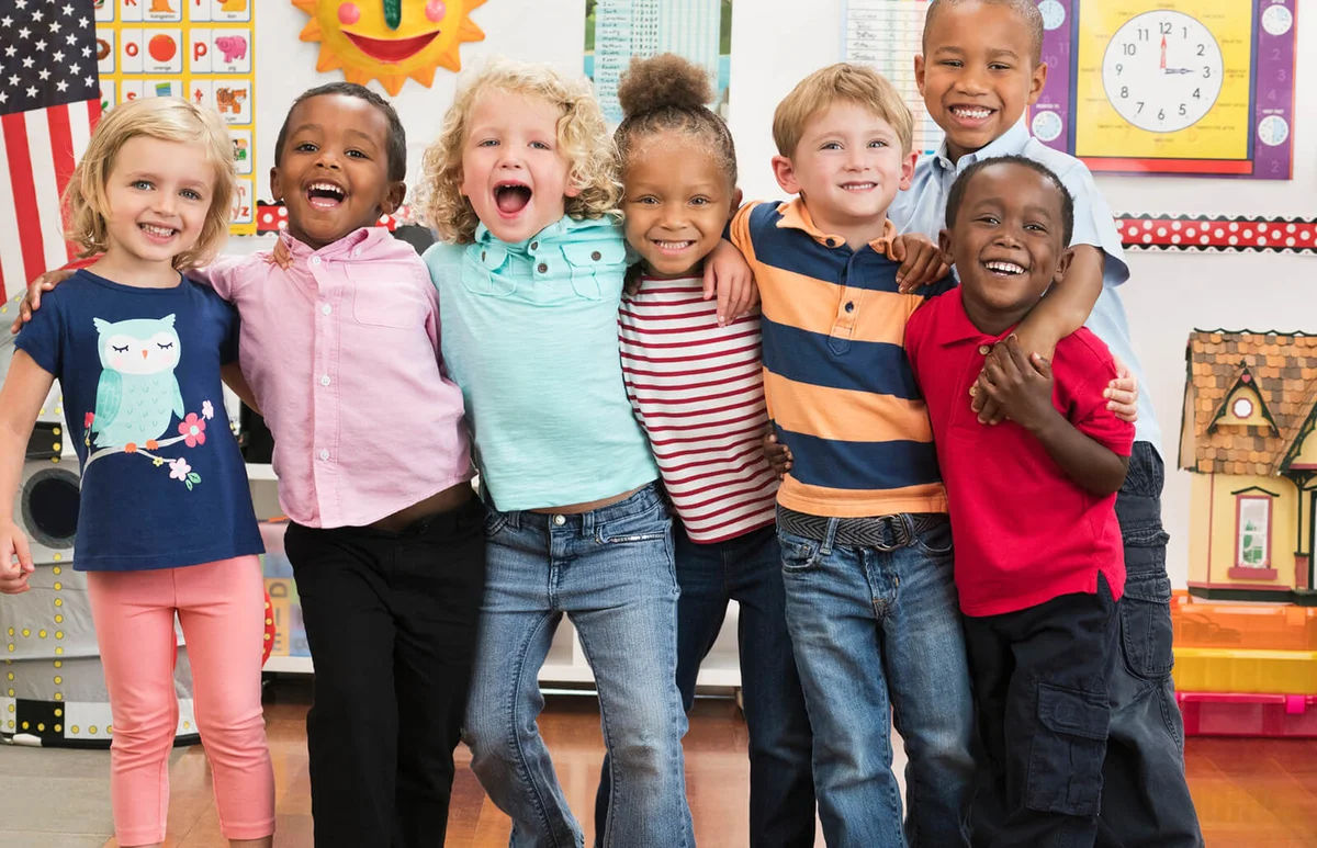 smiling students hugging in classroom