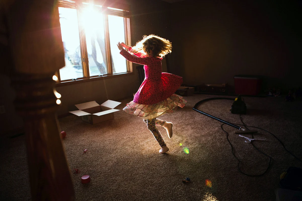 Little girl dancing in living room