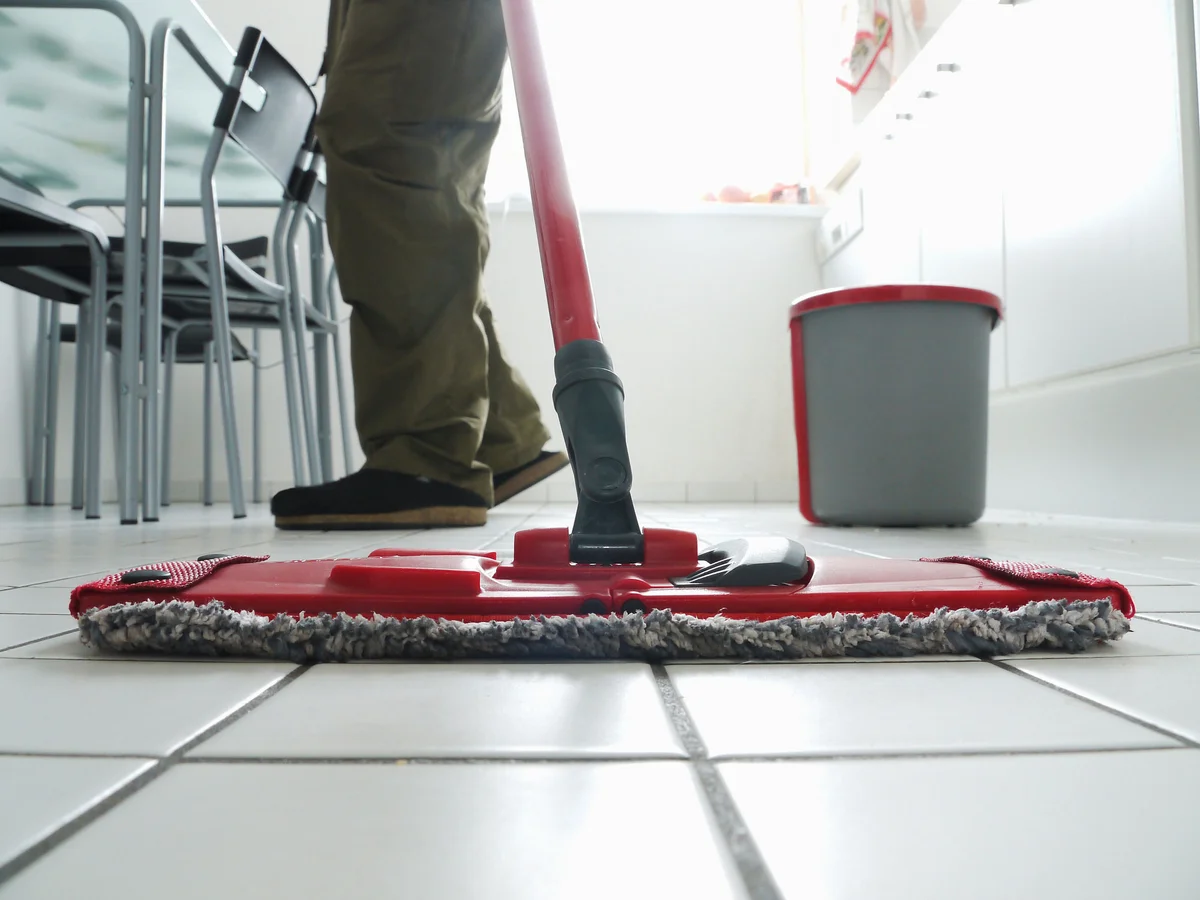 Cleaning kitchen tiles with mop