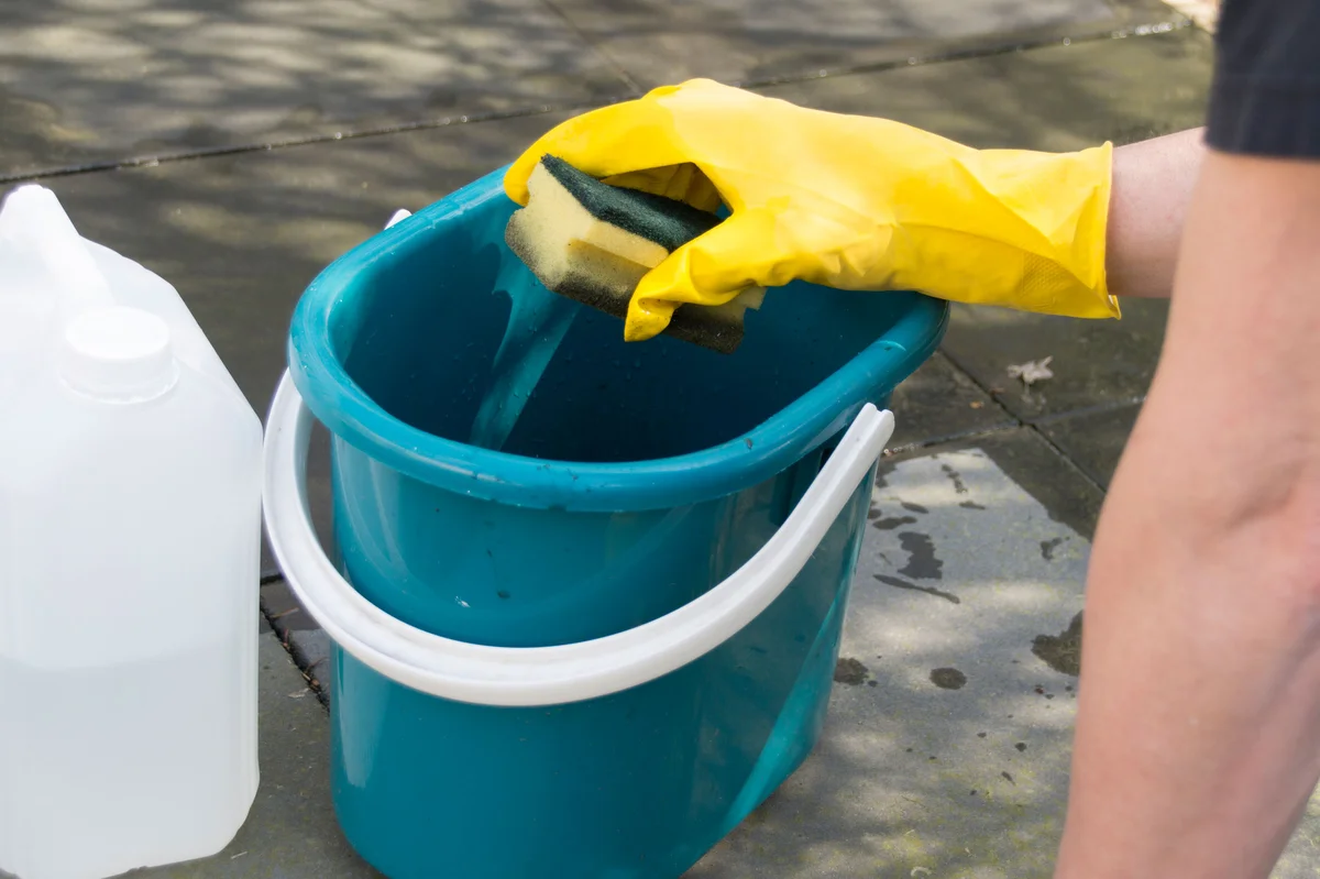 cleaning outdoor tiles with sponge and bucket