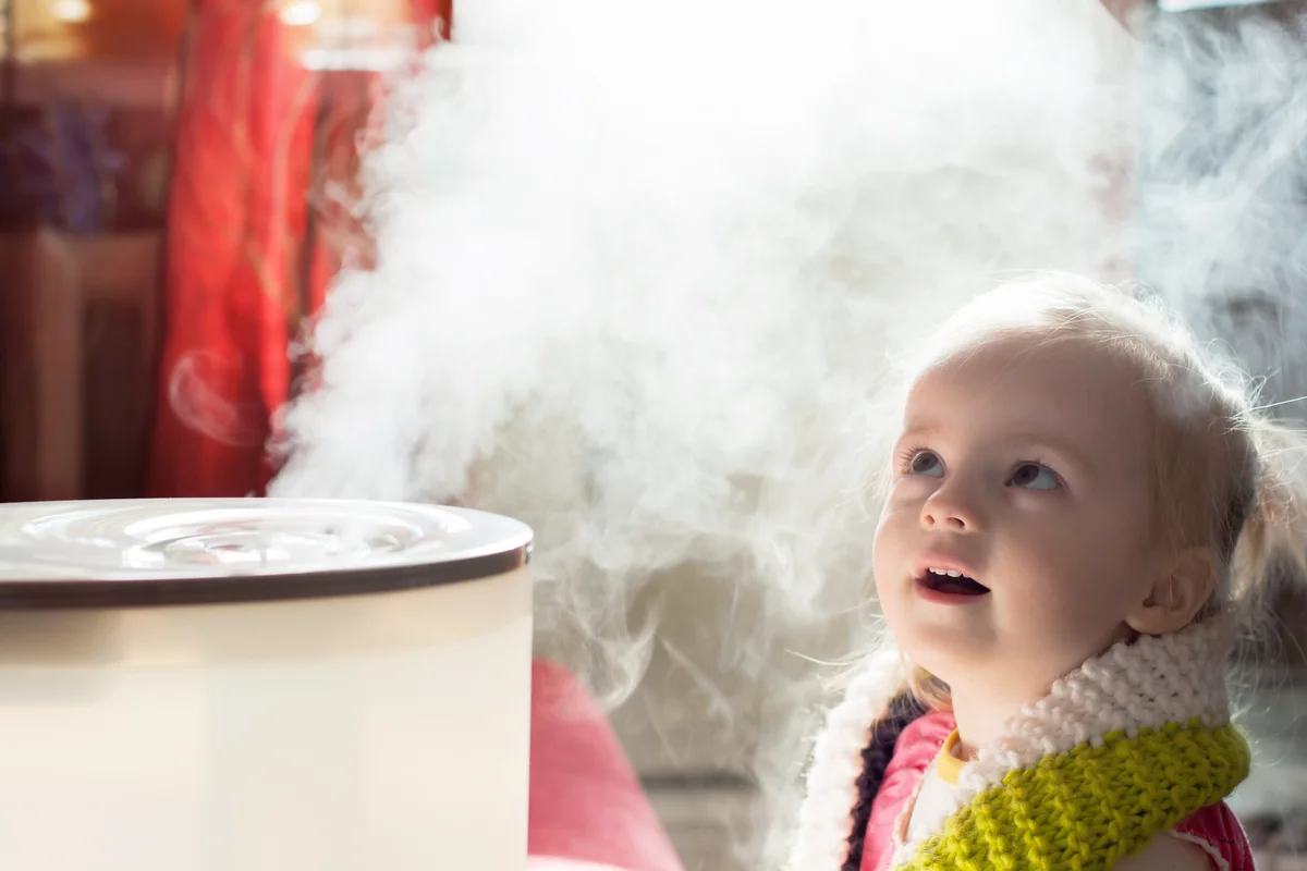 Baby girl with a humidifier