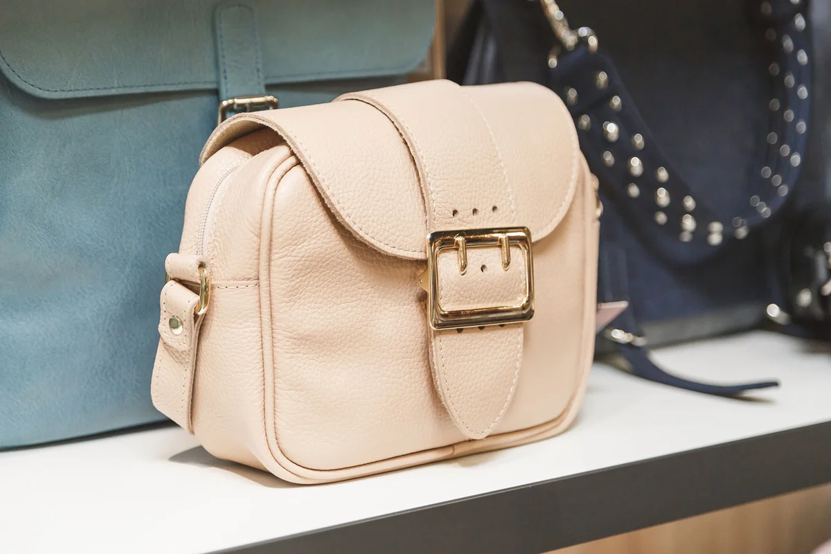 Tan handbag on shelf in store