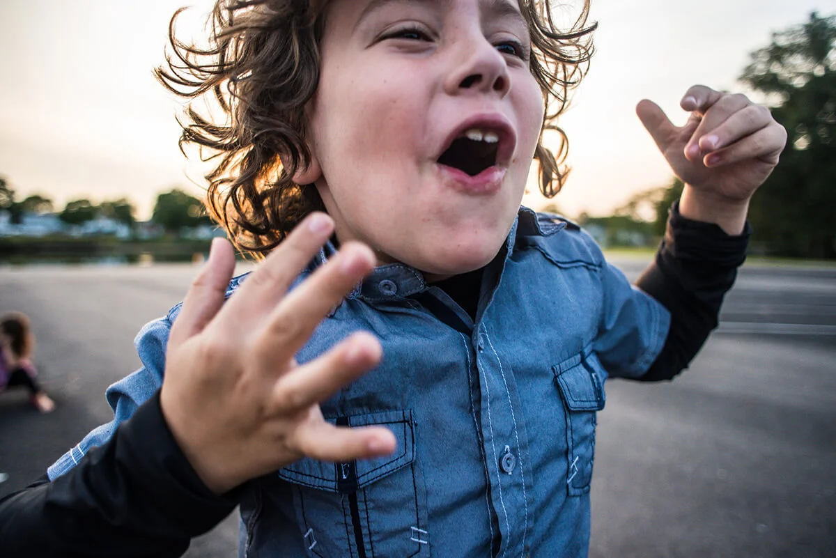 Boy with curly hair cheering