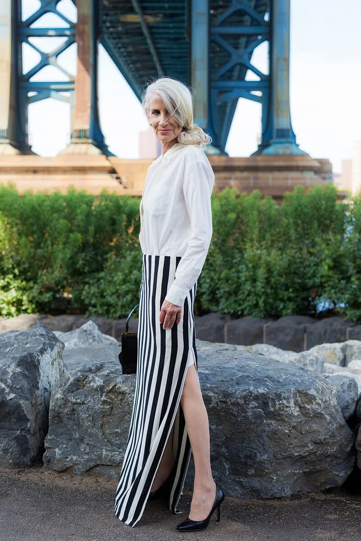 stylish mature woman standing in front of Manhattan Bridge
