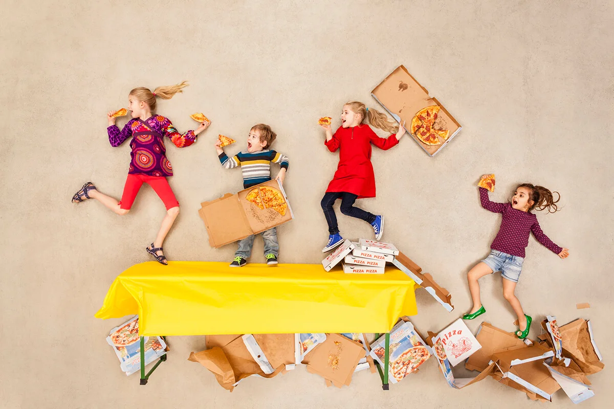 Children eating pizza at party