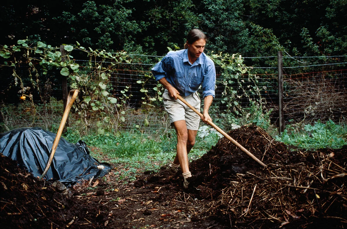 Man shoveling mulch