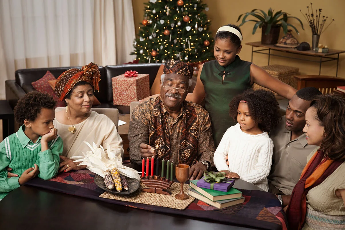 Multi-generation family lighting Kwanzaa candles