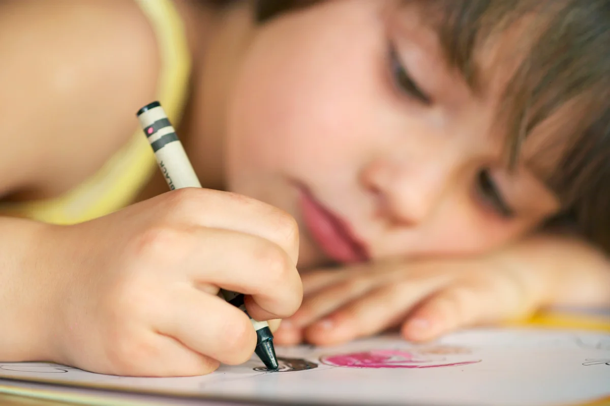 Young Girl Coloring with Crayons