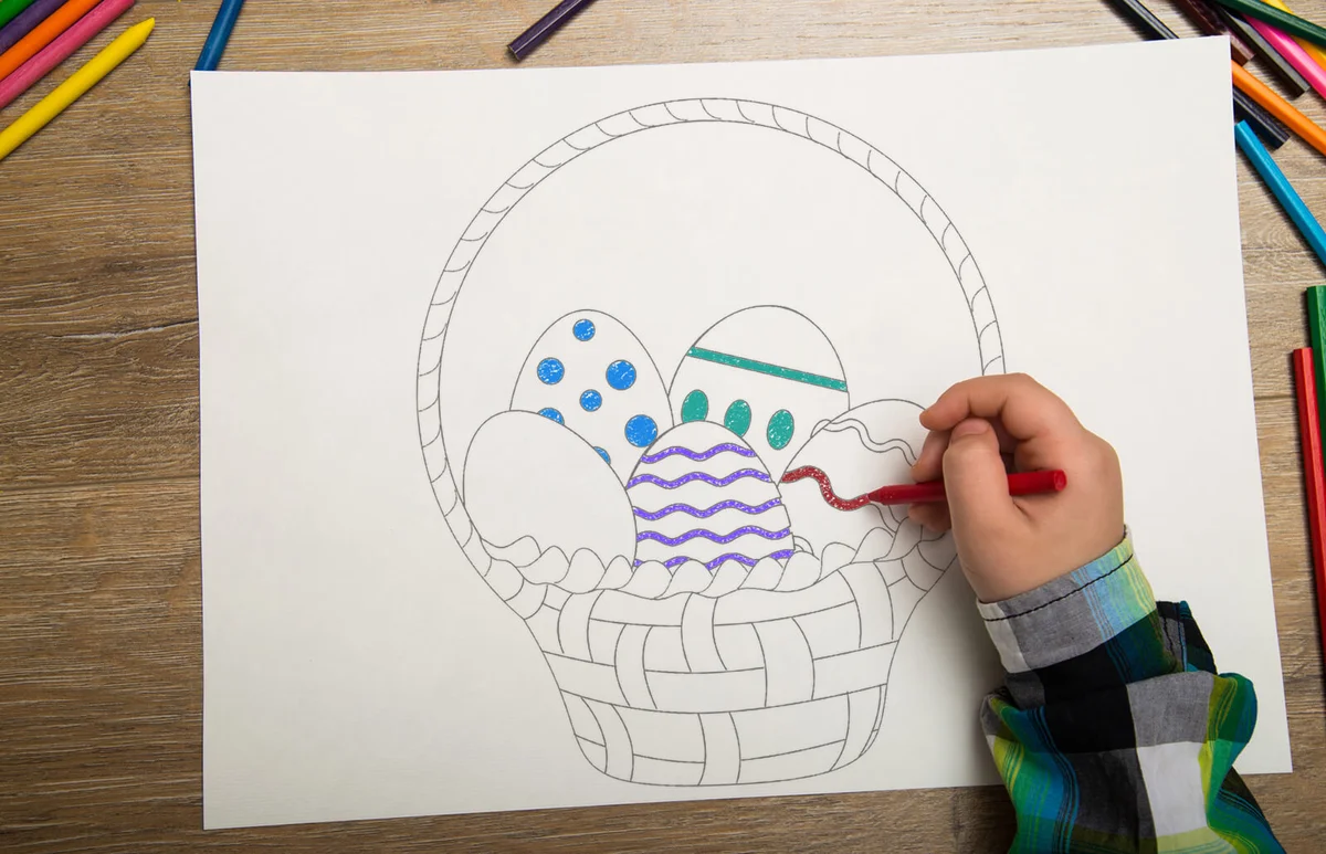Boy drawing with water color and crayons
