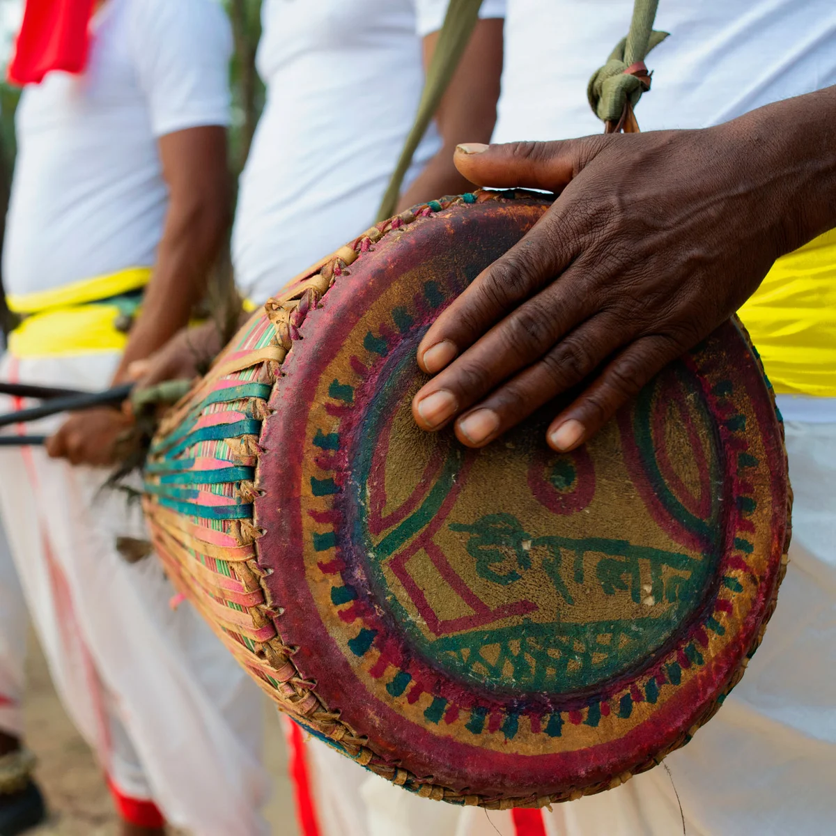 Tribal drummer banging on drum