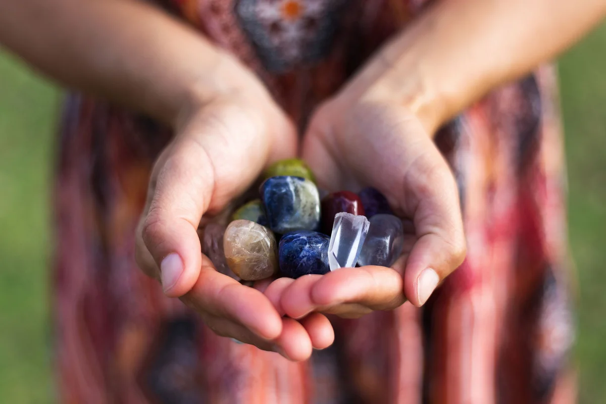 Woman holding handful of gemstones