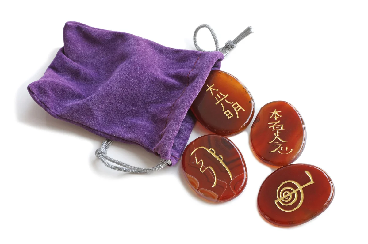 Reiki symbols on stones with purple bag