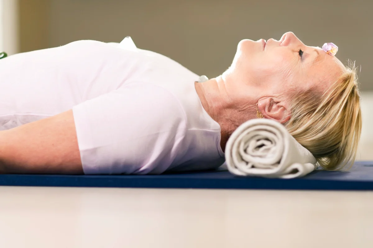 Senior woman relaxing and doing therapy with crystals