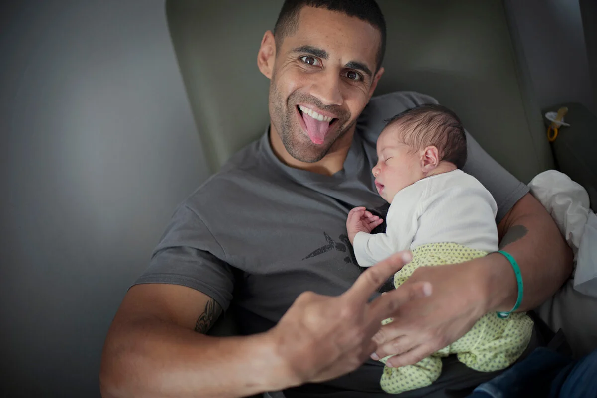 Dad posing with newborn girl