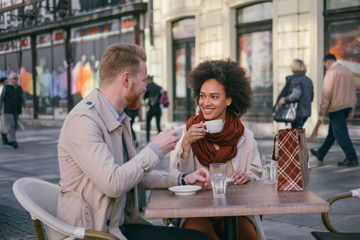 Happy couple having a coffee in the city