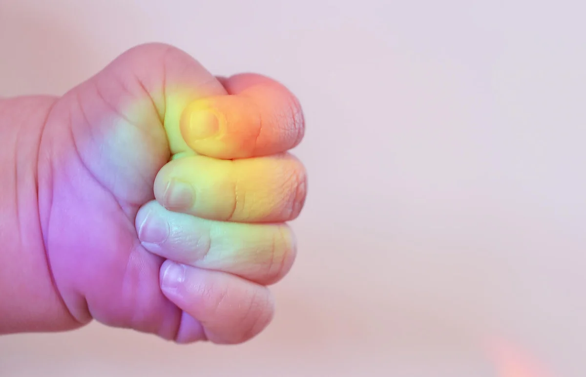 Baby hand with colors of the rainbow