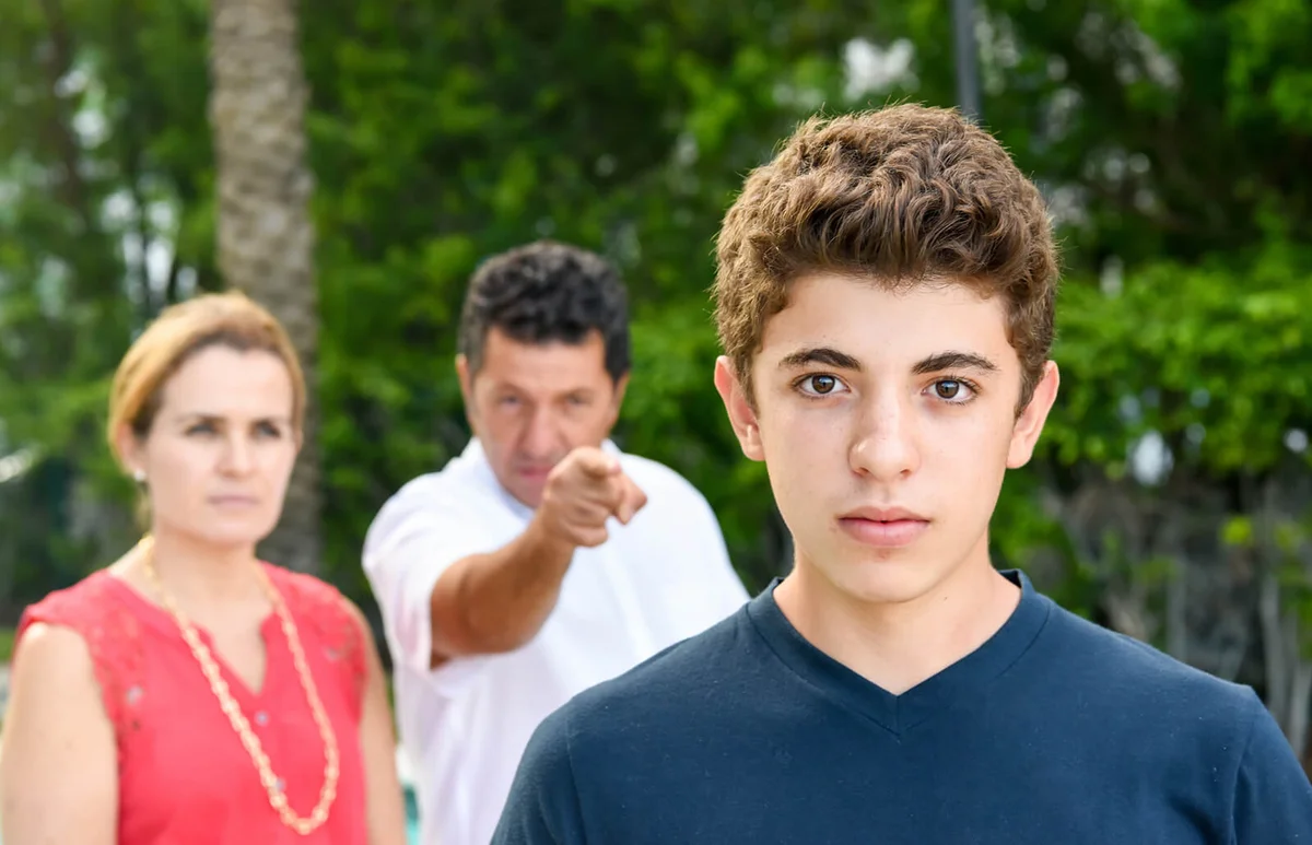 Parents scolding son