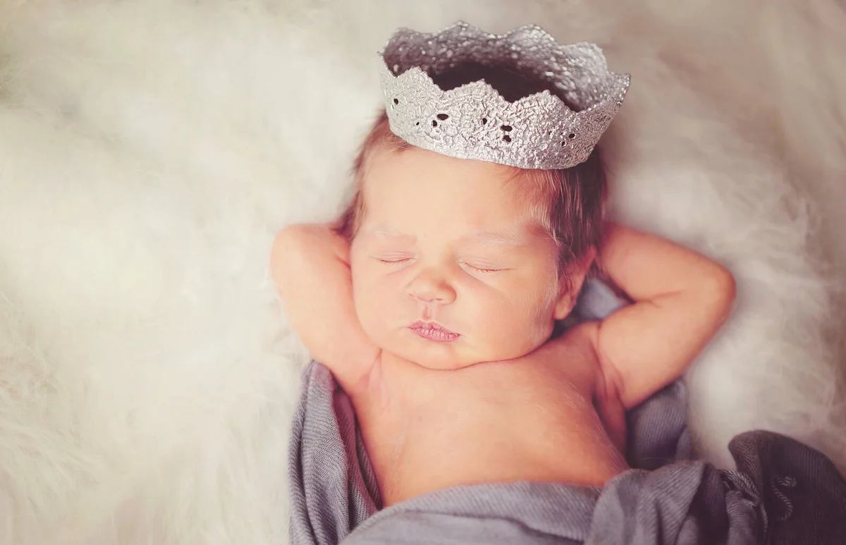 newborn baby wearing silver crown