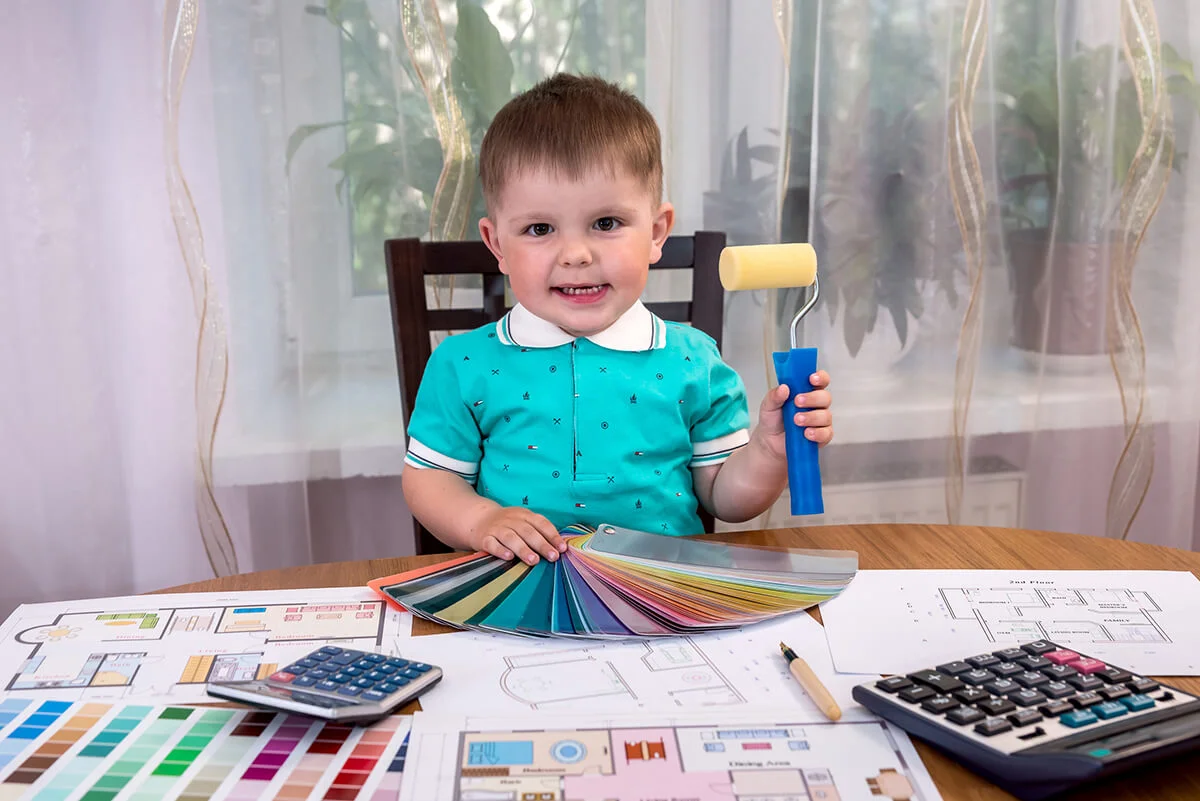 Designer little boy with colour swatch and roller