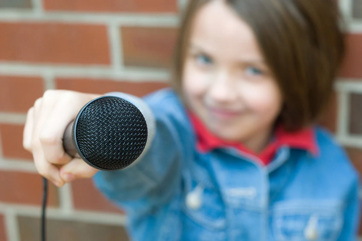 little girl is working on being a reporter