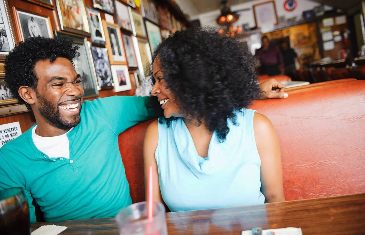 Smiling couple sitting in diner booth