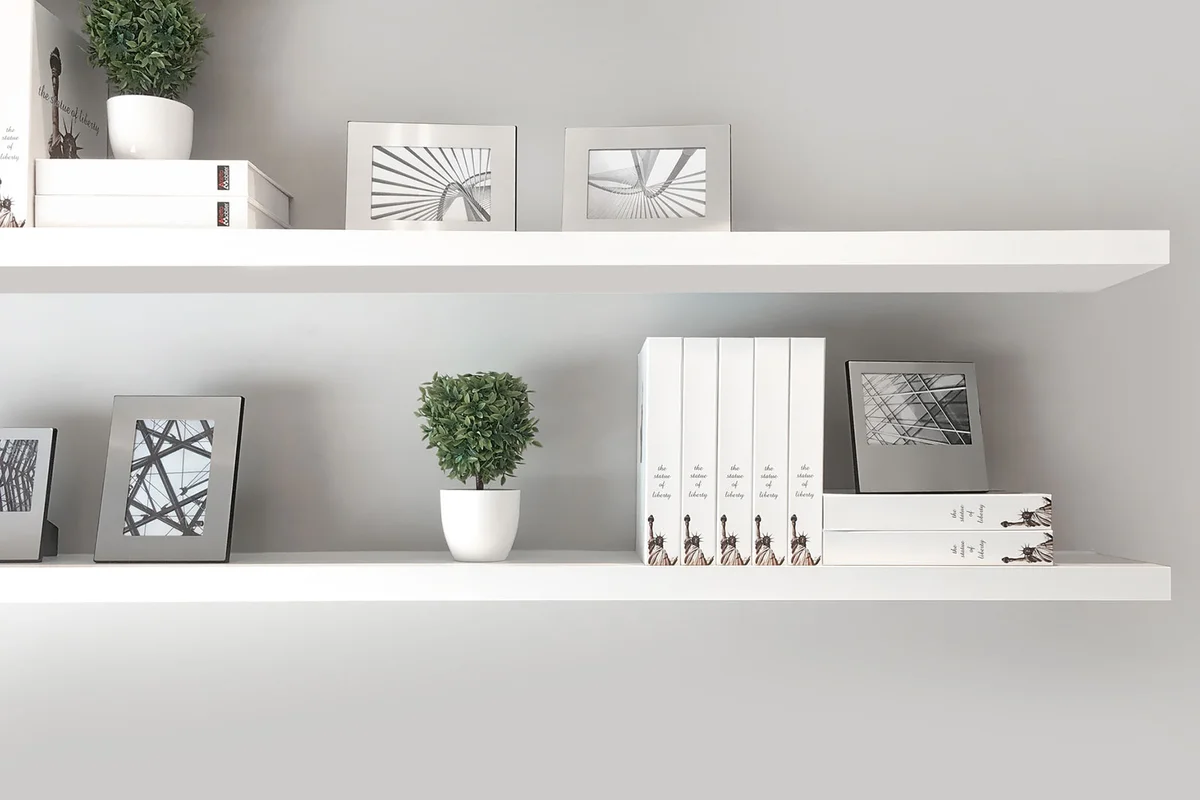 Silver metal frames on white shelf