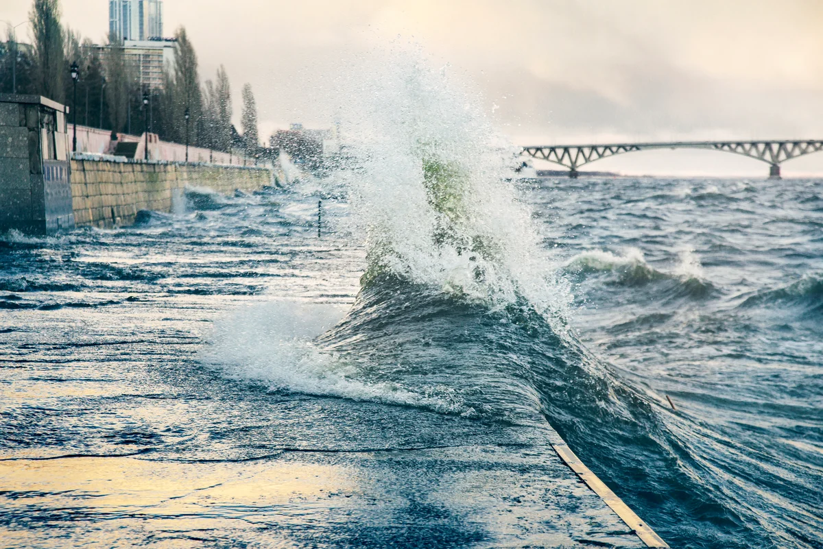 Wave washing onto the promenade of a seaside town