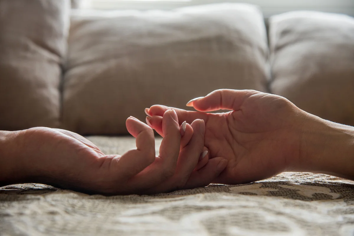 Man and woman touching hands