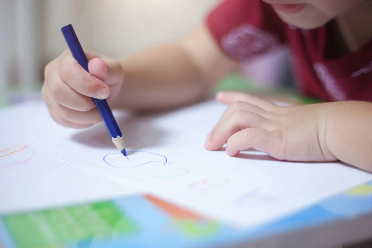 Boy drawing on worksheet